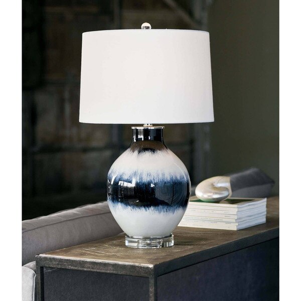 indigo and white colored glass lamp on a wood table